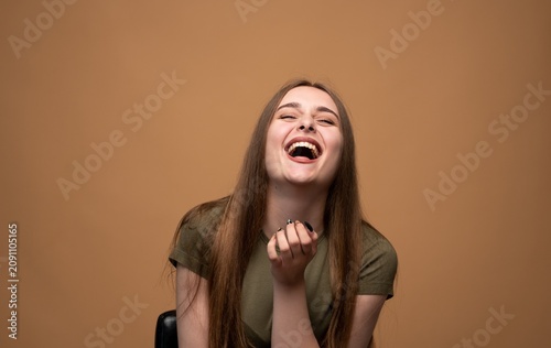 Konstfotografi Young woman bursting with laughter, expressing overwhelming joy and happiness wi