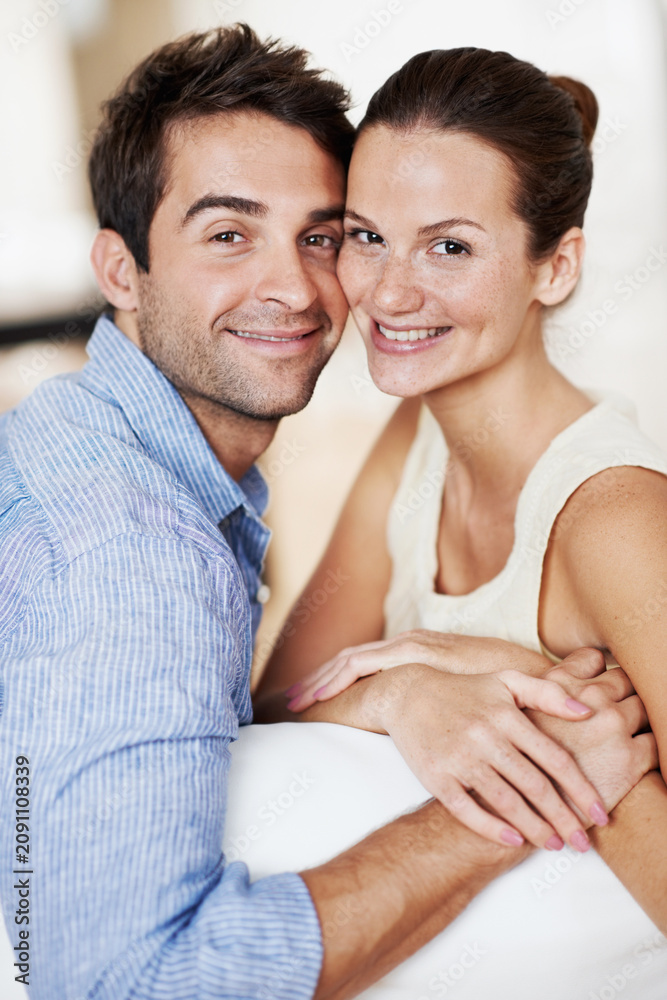 Fototapeta premium Portrait, holding hands and smile with couple on sofa for romance, bonding or support together. Calm, relax and relationship with man and woman in living room of home for marriage, happiness and care