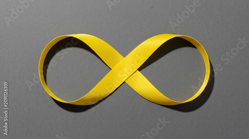Yellow Infinity Symbol Ribbon on Gray Background - Eternity, Endless, Limitless