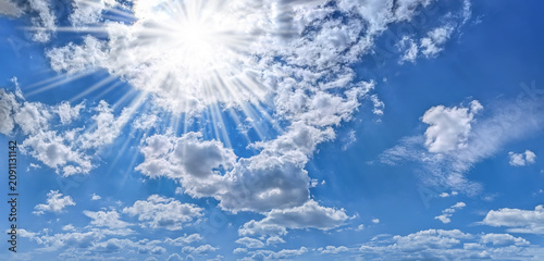 The sky has the light of the sun, the sky is blue, there are small and large clouds alternating and moving slowly, with the sunlight passing, creating a miraculous abstract shape, a hot day.