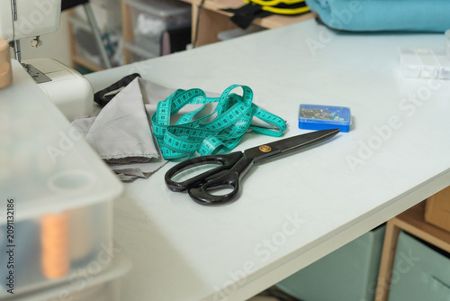 Canvas Print Scissors and measuring tape on a white table with creative chaotic crafting energy indoors