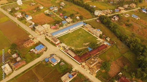 Aerial View of Rural School and Sports Field in Nepal Village	