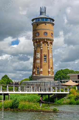 Zwijndrecht, The Netherlands, June 9, 2026: angler by the river bank next to the historic water tower