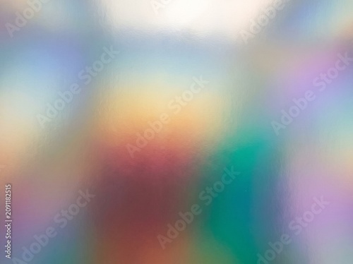A holographic surface shifts from silver to rose gold to teal across the frame — iridescence as a seamless premium background. Ideal for luxury beauty, fashion, cosmetics, tech, and.