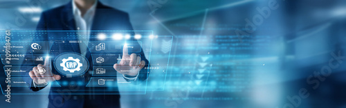 Fotografie Business analyst integrating systems using hands configuring corporate ERP database frameworks upon a high-tech virtual screen tracking resource planning