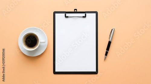Flat lay of clipboard with blank paper, coffee cup and pen on desk