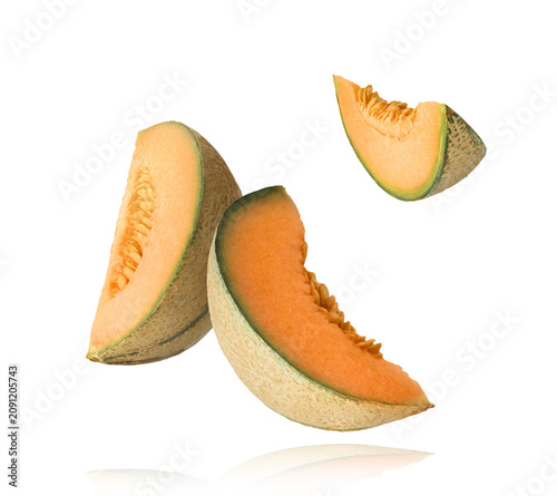 Foto Flying fresh raw ripe cantaloupe melon isolated on a white background