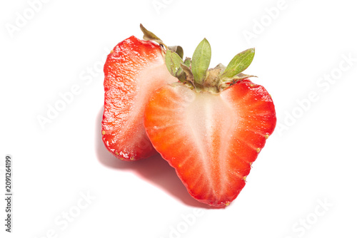 Juicy strawberries cut in half, isolated on white background