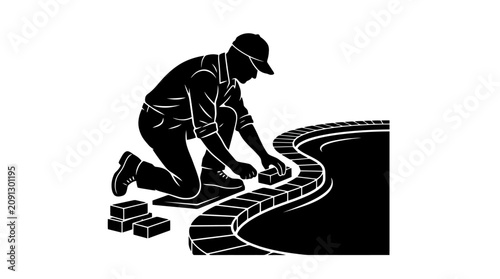 Man laying bricks on a pathway.