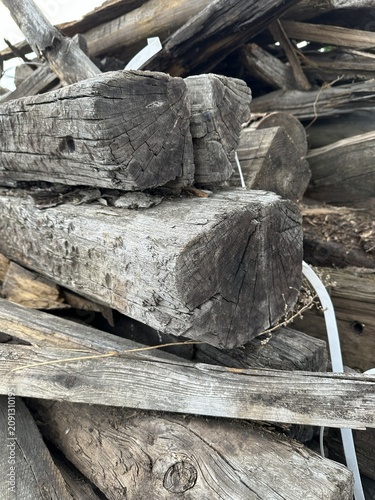 Фотография Close up of old weathered wooden poles with cracked grain texture