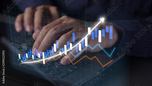 Foto Close-up of a person hands typing on a laptop while digital analytics charts illustrate growth trends and financial projections in a contemporary workspace