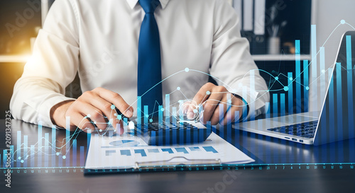 Professional Accountant Using Calculator to Analyze Financial Data and Growth Market Statistics in Modern Office