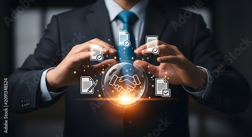 Businessman managing digital business contract agreements with holographic icons of handshake and document signing in professional corporate environment