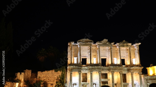Night view of the historic Ephesus Ancient City in Turkey, showcasing illuminated Roman ruins and timeless classical architecture after sunset.