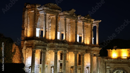 Night view of the historic Ephesus Ancient City in Turkey, showcasing illuminated Roman ruins and timeless classical architecture after sunset.