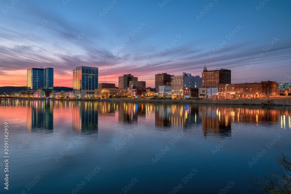 Fototapeta premium Joplin, Missouri cityscape at sunset with reflections on the river