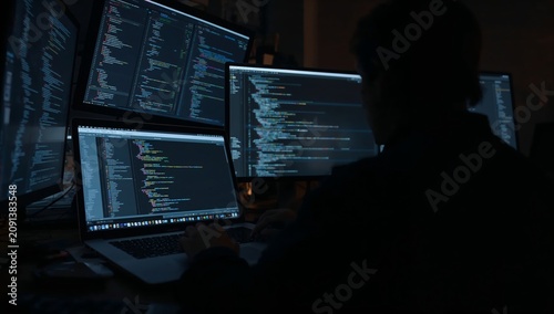 Working on Coding Projects at Night With Multiple Computer Screens