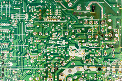Close-up of electronic pathways and soldering points. Detailed information on printed circuit board technology.