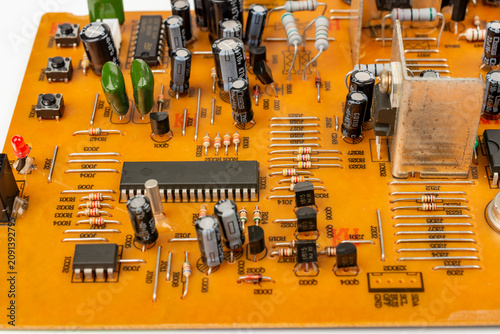 Brown printed circuit board components and parts. electronic circuit board containing radio components from an electronic device.
