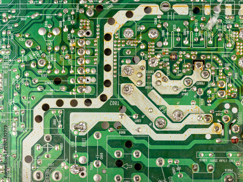 Close-up of electronic pathways and soldering points. Detailed information on printed circuit board technology.