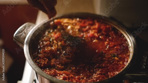 Traditional Ukrainian borscht soup with fresh dill in a metal pot cooking close up