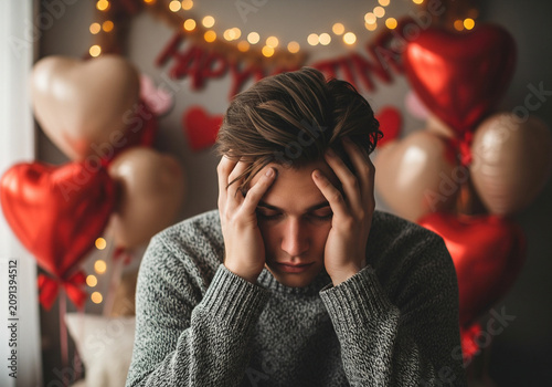 Young Man Sitting Alone on Valentine’s Day, Heartbroken and Vulnerable, Soft Cinematic Editorial Portrait