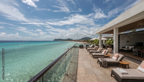 View of Beachside Lounge Area Overlooking Clear Water in Sunny Weather