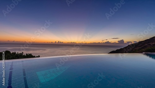 View of Sunset Over Ocean From Swimming Pool on Hillside