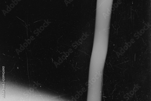 Dark grunge background texture with vertical light streak dust and film scratches