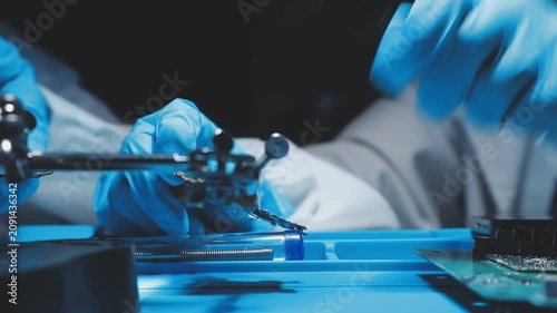 Engineer focuses intently on circuit board assembly
