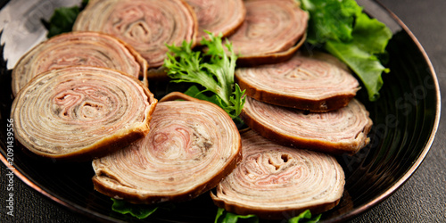 Schilderij op canvas Andouille de Guemene sausage, French cuisine sliced smoked sausages casings meat