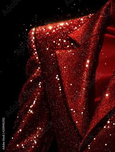 Close-up of a sparkling red sequin suit jacket. Glamorous holiday fashion with glittering light particles on dark background