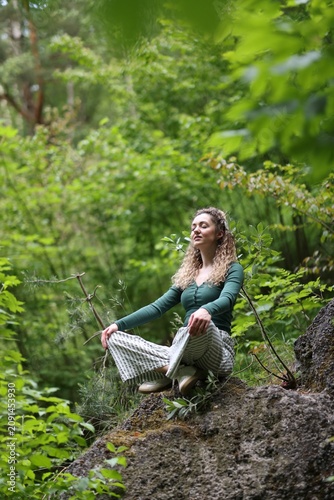 Konstfotografi Relaxation and harmony. Happy woman meditating in park