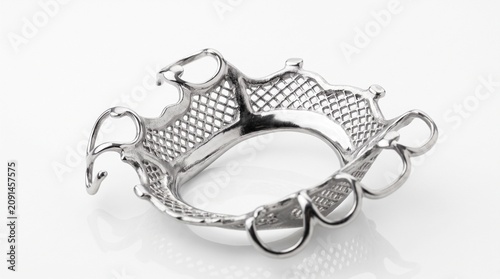 High quality studio view of a highly polished chrome cobalt metal framework for a removable maxillary partial denture, showcasing intricate clasps, major connector, and mesh retention areas on a white