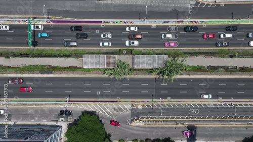 Aerial top-down view of the drone hovering over the Viaducto and Ecoducto in Mexico City with traffic flowing along the multi-lane avenue and green median
