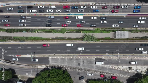 Title: Aerial top-down view of the drone descending over the Ecoducto and Viaducto in Mexico City with heavy traffic flowing along the multi-lane avenue