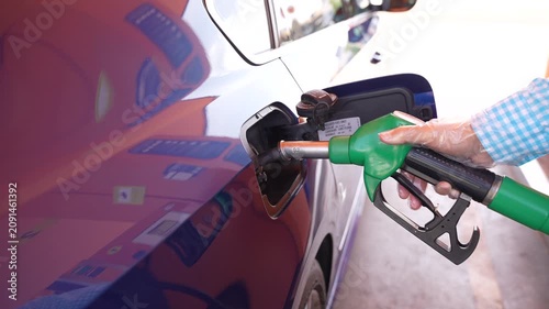 Close Up Refueling Blue Car with Gas Pump at Fuel Station