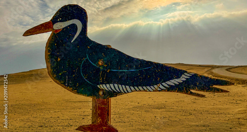 Peru, South America: a wooden sign depicting the zarcillo (Larosterna inca, the Inca tern), an iconic seabird found within the Paracas National Reserve, a protected natural area on the southern coast 