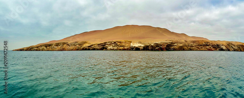 Peru, South America: panoramic view of El Candelabro (The Candelabra, also known as the Trident), impressive and mysterious pre-Inca geoglyph on a sandy hillside in the Paracas National Reserve