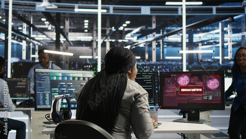 Obraz na plátně Data center engineering team react to a cyberattack on a computer, securing server equipment and protecting confidential data