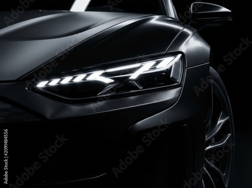 Close-up of a sleek car headlight and sleek black design, showcasing modern engineering and luxury.