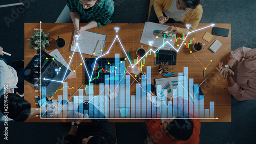 Foto A diverse group of professionals collaborates at a workspace, analyzing financial charts and graphs to uncover data insights and develop business strategies