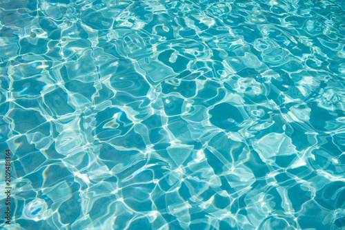 Summer vacation at ocean shore. Blue ocean rippled water texture reflection. Ripple water in summer pool. Sea surface background. Vacation resort water background. Sea beach