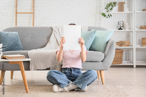 Young woman holding a blank...