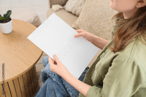 Woman holding a blank white...