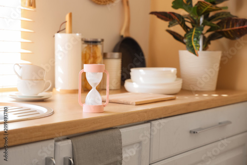 Pink hourglass timer on a w...