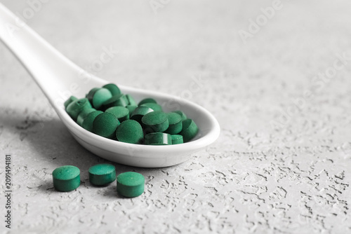 Spoon with spirulina tablet...