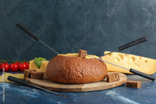 Board with cheese fondue in...