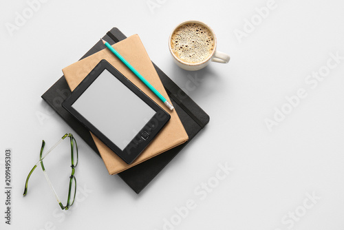 Modern e-reader with books,...