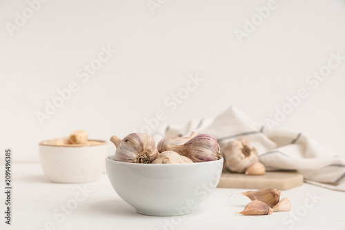 Bowl with fresh garlic and ...
